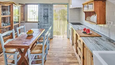 a kitchen with a wooden table and a sink at Casa García Camacho Conil de la Frontera by Ruralidays in Conil de la Frontera