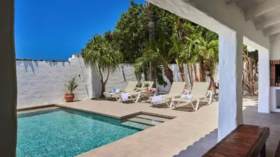 a house with a swimming pool and chairs and trees at Casa García Camacho Conil de la Frontera by Ruralidays in Conil de la Frontera