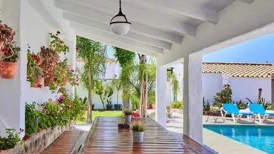 a house with a swimming pool and a wooden walkway at Casa García Camacho Conil de la Frontera by Ruralidays in Conil de la Frontera
