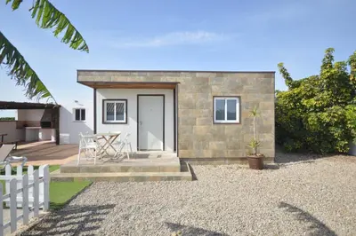 a small brick house with a white door at Casas Buenavista in Conil de la Frontera