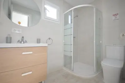 a bathroom with a shower with a toilet and a sink at Casas Buenavista in Conil de la Frontera