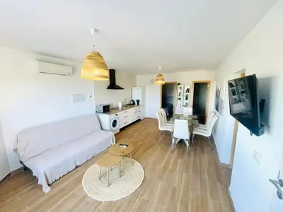 a living room with a white couch and a table at Casas Buenavista in Conil de la Frontera