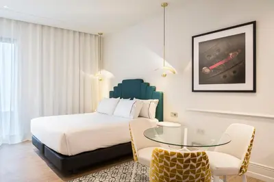 a bedroom with a bed and a glass table at Tandem Solera in Jerez de la Frontera