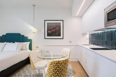 a bedroom with a bed and a table and chairs at Tandem Solera in Jerez de la Frontera