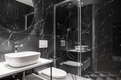 a black and white bathroom with a sink and a shower at Tandem Solera in Jerez de la Frontera