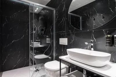 a black and white bathroom with a sink and a shower at Tandem Solera in Jerez de la Frontera