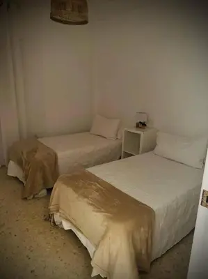 a room with two beds in a room at Bonito y ubicación inmejorable in Sanlúcar de Barrameda