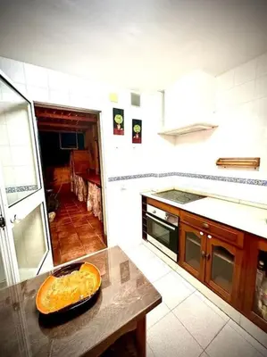 a kitchen with a table with a bowl of food on it at Bonito y ubicación inmejorable in Sanlúcar de Barrameda