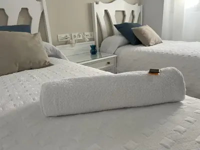 two beds in a white room with at Jardines del Porvenir 2 in Puerto Real