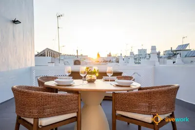 a table and chairs on a balcony with a view at Terrace Home by LiveWork in Cádiz