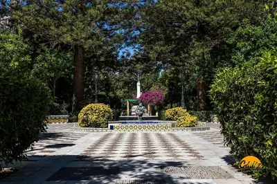 a park with a fountain and flowers and trees at Terrace Home by LiveWork in Cádiz
