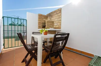 a dining room with a table and chairs on a balcony at Apartamento Casa Postas II in Conil de la Frontera