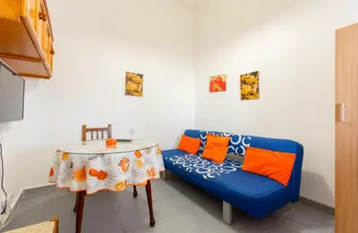 a living room with a blue couch and a table at Apartamento Casa Postas III in Conil de la Frontera