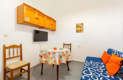 a living room with a table and a couch at Apartamento Casa Postas III in Conil de la Frontera