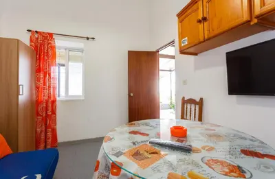 a dining room with a table and a tv at Apartamento Casa Postas III in Conil de la Frontera