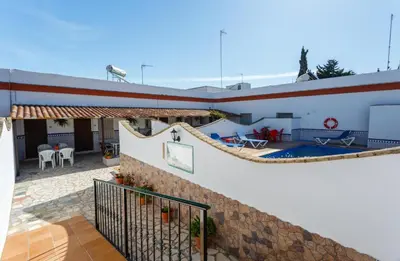 a house with a pool and a large boat at Apartamento Casa Postas III in Conil de la Frontera