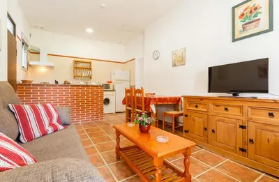a living room with a couch and a flat screen tv at Apartamento Casa Postas IV in Conil de la Frontera