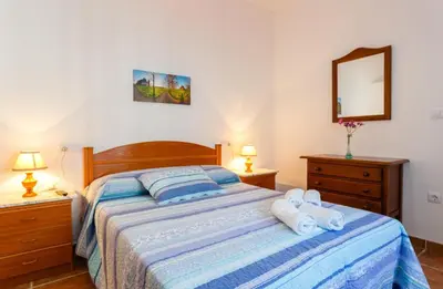 a bedroom with a bed with towels on it at Apartamento Casa Postas IV in Conil de la Frontera