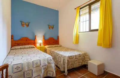 a bedroom with two beds and a window at Apartamento Casa Postas IV in Conil de la Frontera