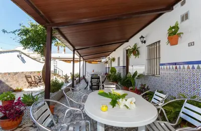 a patio with a white table and chairs at Apartamento Casa Postas IV in Conil de la Frontera