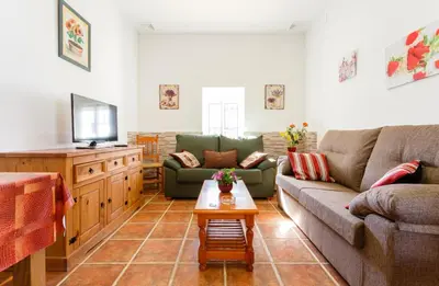 a living room with a couch and a table at Apartamento Casa Postas IV in Conil de la Frontera