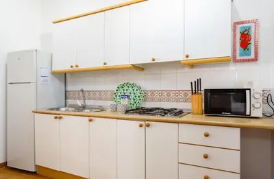 a kitchen with white cabinets and a white refrigerator at Apartamento Casa Postas I in Conil de la Frontera