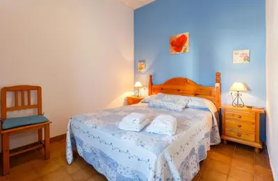 a bedroom with a bed with two towels on it at Apartamento Casa Postas I in Conil de la Frontera