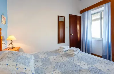 a bedroom with a bed with towels on it at Apartamento Casa Postas I in Conil de la Frontera