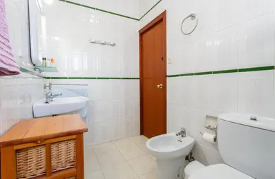 a white bathroom with a toilet and a sink at Apartamento Casa Postas I in Conil de la Frontera