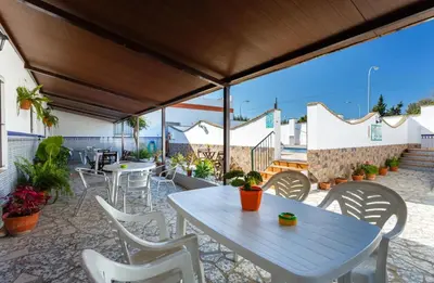 a table and chairs on a patio with a view at Apartamento Casa Postas I in Conil de la Frontera