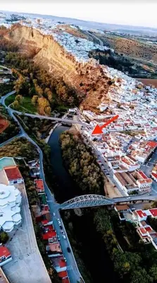 an aerial view of a city with a bridge and a river at Casa Mirador del Puente in Arcos de la Frontera