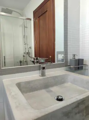 a bathroom with a large sink with a mirror at Casa Mirador del Puente in Arcos de la Frontera