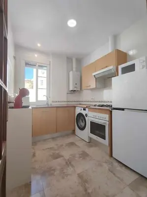 a kitchen with a white refrigerator and a dishwasher at Casa Mirador del Puente in Arcos de la Frontera