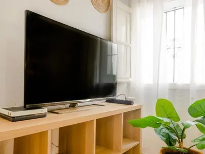 a flat screen tv sitting on top of a table at Las Torres 197 in Novo Sancti Petri