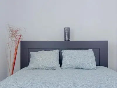 a bedroom with a blue bed with two pillows at Las Torres 197 in Novo Sancti Petri