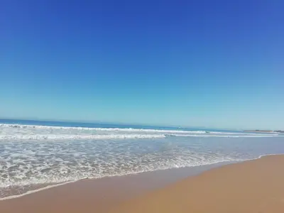 a sandy beach with the ocean in the background at Las Torres 197 in Novo Sancti Petri