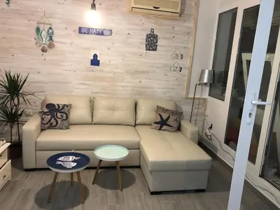 a living room with a couch and a table at Precioso Ático en el Centro Histórico de Cádiz in Cádiz
