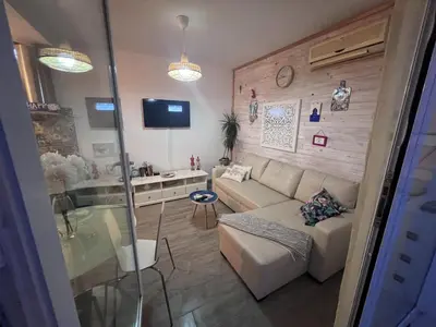 a living room with a couch and a table at Precioso Ático en el Centro Histórico de Cádiz in Cádiz