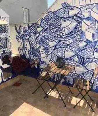 a room with a blue and white mosaic wall at Precioso Ático en el Centro Histórico de Cádiz in Cádiz