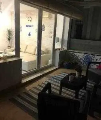 a living room with a couch and a table at Precioso Ático en el Centro Histórico de Cádiz in Cádiz