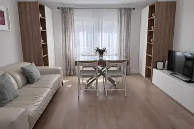 a living room with a table and a couch at Apartamento Amaro Cádiz - Playa Victoria in Cádiz