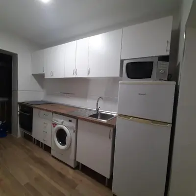 a kitchen with a sink and a washing machine at Piso cercano al recinto ferial in Jerez de la Frontera