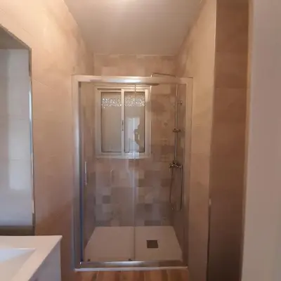 a shower with a glass door in a bathroom at Piso cercano al recinto ferial in Jerez de la Frontera