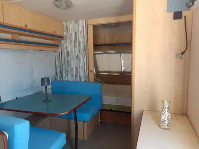 a living room with a couch and a table and chairs at movilhome en paraiso in Chiclana de la Frontera