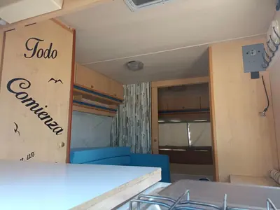 a small room with two bunk beds in it at movilhome en paraiso in Chiclana de la Frontera