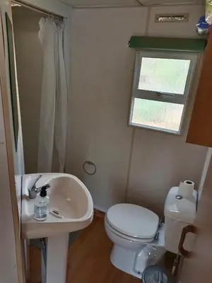 a small bathroom with a toilet and a sink at movilhome en paraiso in Chiclana de la Frontera