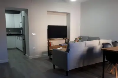 a living room with a couch and a television at Sanlucar-Centro in Sanlúcar de Barrameda