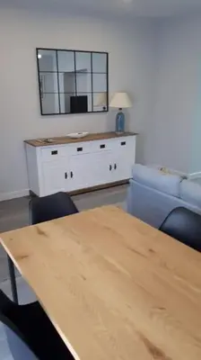 a living room with a table and a mirror at Sanlucar-Centro in Sanlúcar de Barrameda