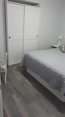 a bedroom with a bed and a white cabinet at Sanlucar-Centro in Sanlúcar de Barrameda
