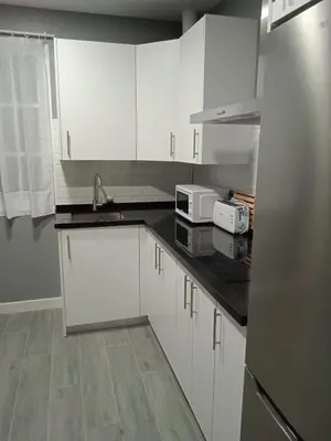 a kitchen with white cabinets and a sink at Sanlucar-Centro in Sanlúcar de Barrameda